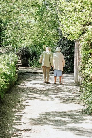 two seniors walking in the park