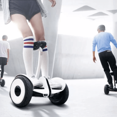 three people riding electric hoverboard