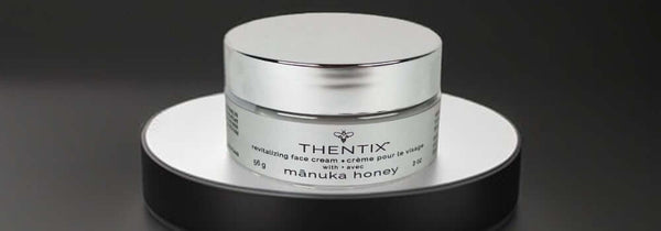 Thentix face cream made with manuka honey on a platform.