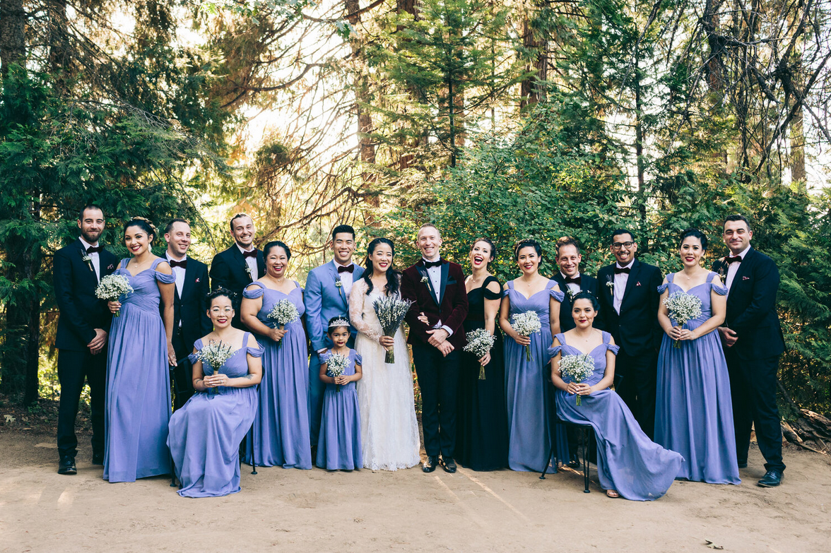 Peony Rice Bride Caitlin with her wedding party bridesmaids dresses in periwinkle blue and groomsmen in forest green suits