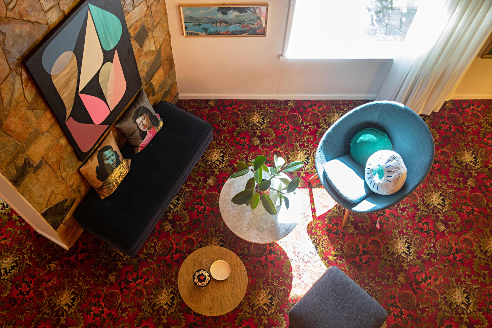 Foyer with sofas, art work, and sunshine. 