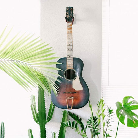 How high to hang a guitar on the wall?