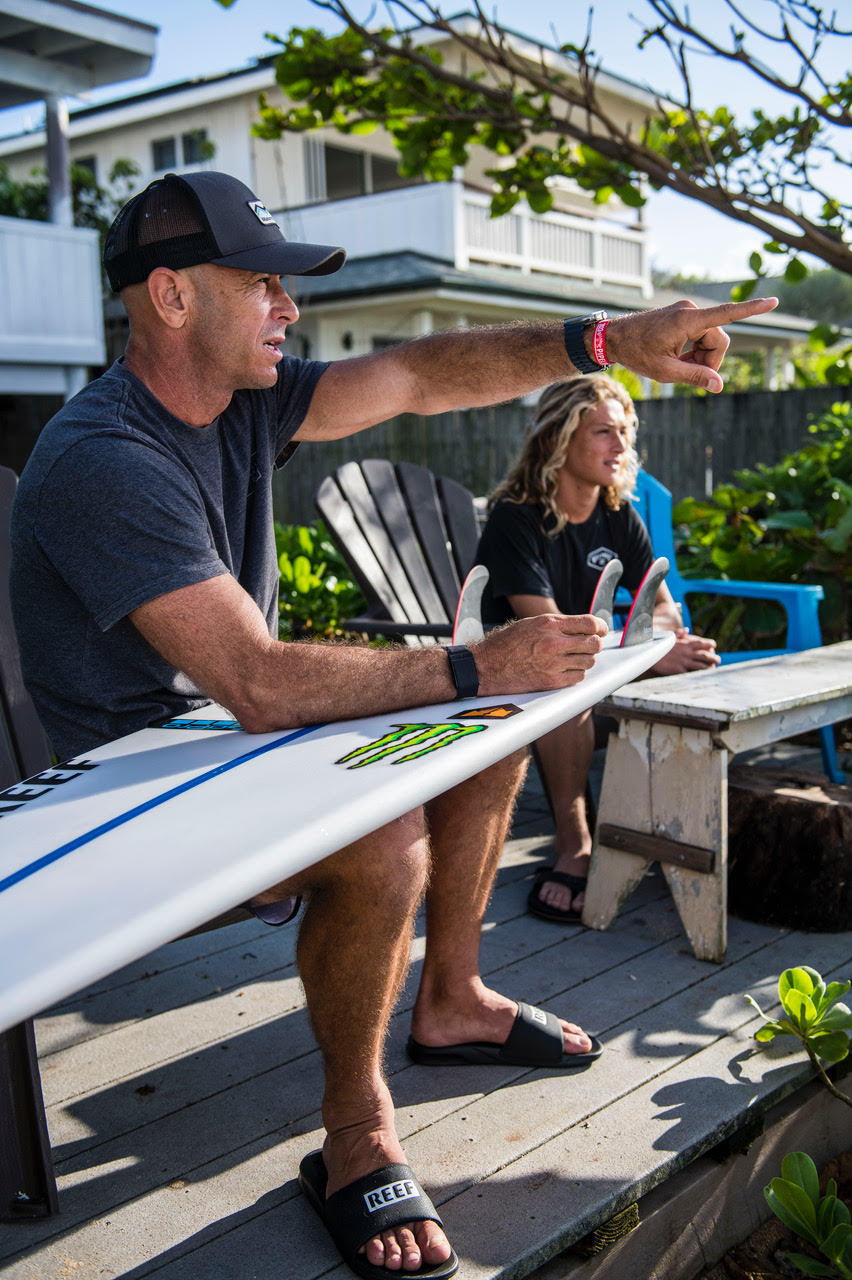 Shane Dorian preparing his surf board.