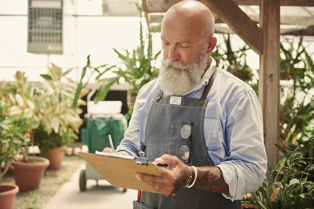 Gardener Peter Volenec-Hamel wearing an Artifact Garden Apron