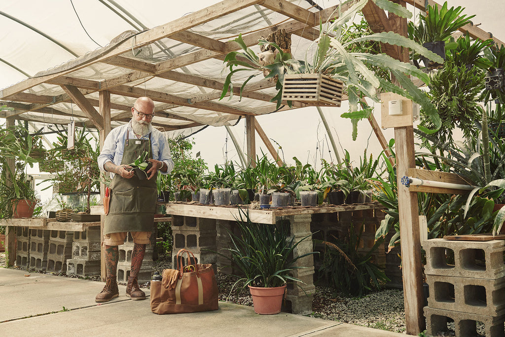 Gardener Peter Volenec-Hamel wearing an Artifact Garden Apron