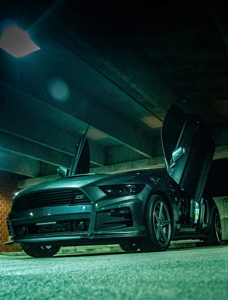 Check out Ron's Ford Mustang, Roush RS1 Edition from Tennessee featuring Vertical Lambo Doors Conversion Kit from Vertical Doors, Inc.  Thank you for the images Ron  IG: eco_roush1 Youtube: https://youtu.be/O2NKnM05qmI Facebook: GreatRondini    <hr>I have been working on my car for the past 2 years and have been lightly modifying it. It is aesthetically pleasing on the eyes and I get tons of compliments daily. Since I have been working on my car for the last 2 years, I have attended several car meets, Cars and Coffee monthly meets, Motors and Mouths monthly meets, numerous car shows (out of which I allowed my car to be judged 2 times and I got 2 trophies), The Mustangs At The Mountain Annual Event (next event is in May), The Jordan High School Annual Car Show the past 2 years (next event is next month), I plan on attending the NMRA/NMCA ALL-STAR Nationals Car Show on April 6th. I am part of several Mustang groups and 2 local car clubs.  My car has an amazing background story beginning with the fact that I was struggling to find a nice sports car that fit me. After searching for 3 straight months, I finally found it! My 2015 Roush RS1 was used but it was the newest and nicest car I have ever owned. I immediately wanted to add to the looks and bought louvers for the back window and side windows.  One week before Christmas 2018, my car was vandalized in Memphis, TN while i was gone for work. The criminals broke my pasenger side window and took my wheel lug key and stole my performance package wheels, tires, and also damaged my louvers and brake calipers. Since then I have brought my car back to life and "Phoenix" rose from the ashes!  From there it has skyrocketed with my determination to make my car the best that I can!   My current mods are as follows:  *ETS Front Mount Racing Intercooler  *COBB OTS Stage 2/93 Octane *Tune *Custom Roush Decals  *LED Under Glow Lights *Mishimoto Single Catch Can *MMD Resonator Delete  *19" Advanti Caminno Matte Gunmetal Wheels Staggered *19x8.5 Front Wheels *19x9.5 Rear Wheels  *25 MM Wheel Spacers On Front And Rear *Custom Motor Cover Graphics *Custom Made Roush Wheel Cap Emblems *Phoenix Automotive 10.4" Vertical Tesla Style Touchscreen Radio *1 TB External Harddrive  *Custom Painted ROUSH Decklid Lettering *ZL1 Roush S poiler Wickerbill Add-on  Upcoming Mods include:  *Custom Built 4th Order Bandpass Subwoofer Enclosure With Custom LED Lighting (Currently Building) *Audiopipe APCLE -15001D Amplifier (Purchased) *Audiopipe XV-BXP-SUB Digital Bass Processor  (Purchased) *American Bass ELITE-1244 Single 12" Subwoofer (Purchased) *Custom Built Rear Seat Delete (Currently Building) *PLM Stainless And Catless Downpipe (Purchased) *Turbosmart Wastegate Actuator (Purchased) *Protune By Purple Drank Tuning *NGK One Step Colder Plugs *Air Ride Suspension   I am working on taking my social media to the next level as i am building more of a fan base. My Instagram is @eco_roush1 and same with YouTube. I want to get more into creating and posting videos.   Ron Kent   . . Ford Mustang 2015-2019 Lambo Door Conversion Kit by Vertical Doors Inc. Part Number: VDCFM15  This kit will fit FORD MUSTANG ALL 2015, 2016, 2017, 2018, 2019 Vertical Doors, Inc. is the only manufacturer of Vertical Lambo Doors and ZLR Door Conversion in the USA. All Vertical Doors, Inc. kits are proudly made 100% in the USA. This kit will fit all models of the 6th Generation Ford Mustang. Easy Intallation No Welding Free Tech support  #ford #mustang #6thgen #stang #VerticalDoorsInc #LamboDoors #VerticalDoors #DoorConversion #MadeintheUSA #USA #doors #love #happy #picoftheday #repost #style #swag #work . . Hi, can you send us your best high resolution images to social@verticaldoors.com and also if you have a car meet, car show or any event where your vehicle will be featured let us know and we can promote it on our Social Media and “Event” page at no cost. (If event, please send pic/banner and text with event info). Please include Car Info, Car Club Info, Shop Info, Marketing Company, photographer info and social medial names for built credit in the post. Thank you.