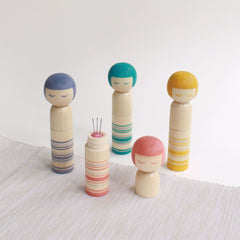 A charming pincushion disguised as a traditional kokeshi doll from northern Japan.  Designed as the traditional sleek shape and bobbed hair of the kokeshi, in Cohana's signature colours. The magnetic doll's base picks up fallen pins and needles.