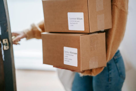 a woman holding the boxes