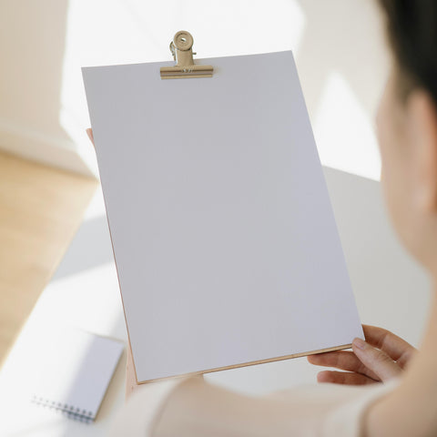 A Woman Holding a Blank White Paper