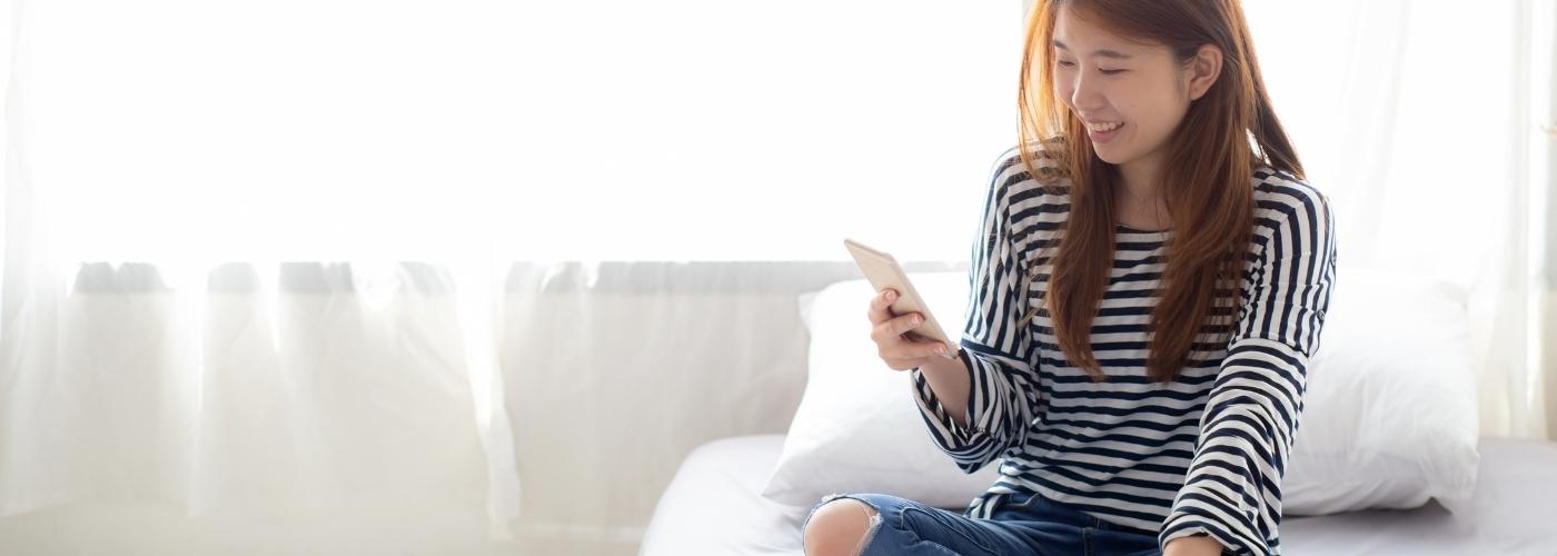 woman sitting on bed