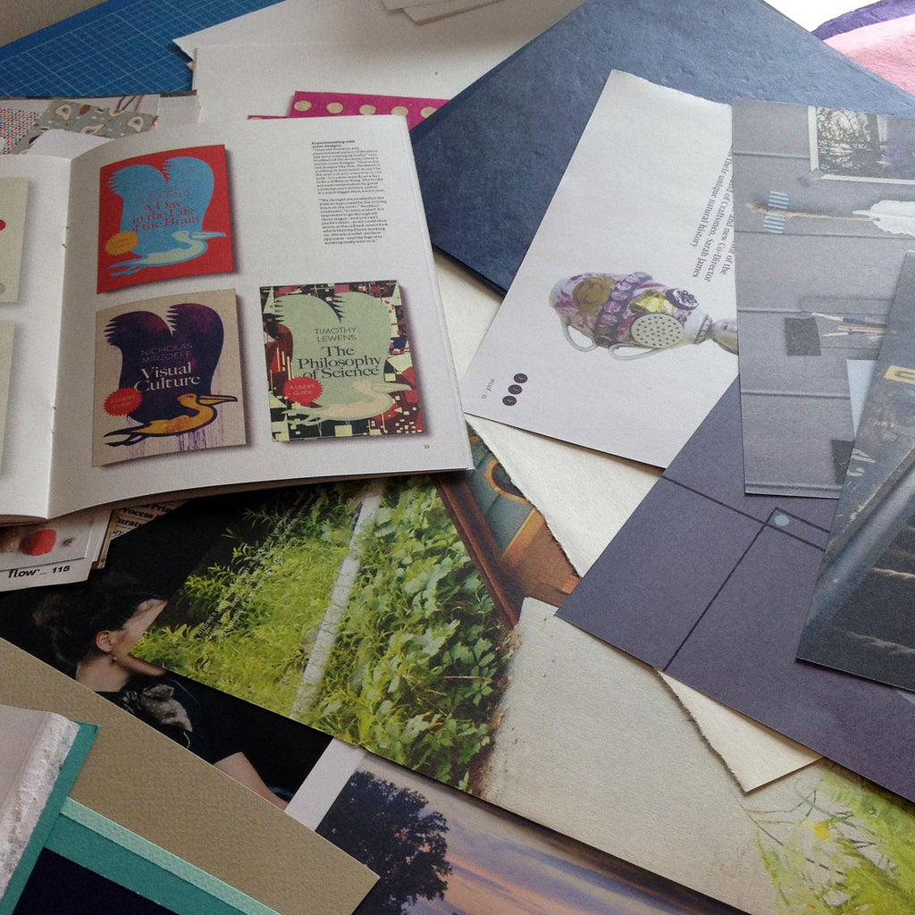 Choosing repurposed papers from old magazines and books.