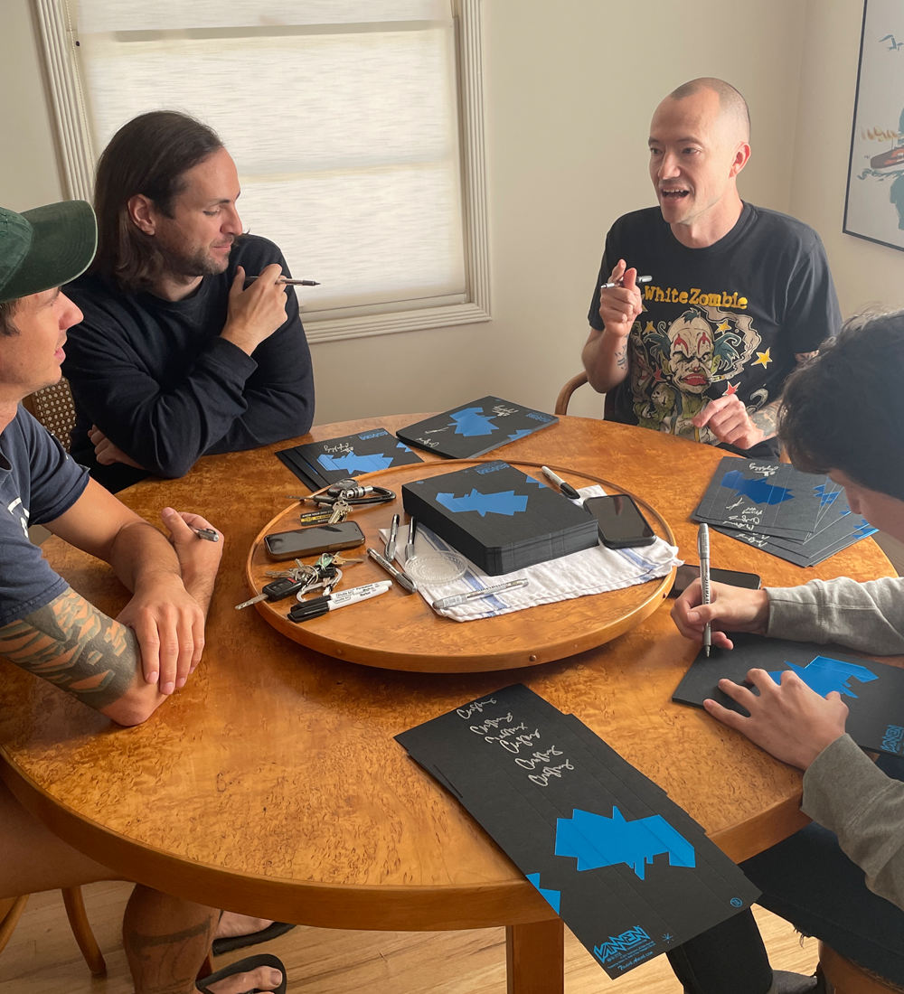 Members of Touche Amore signing Vannen watches packaging