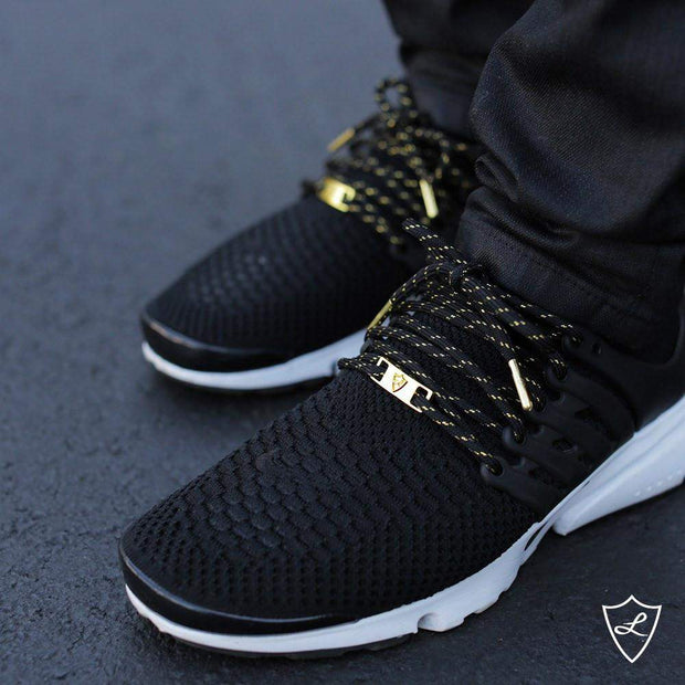 black shoelaces with gold tips