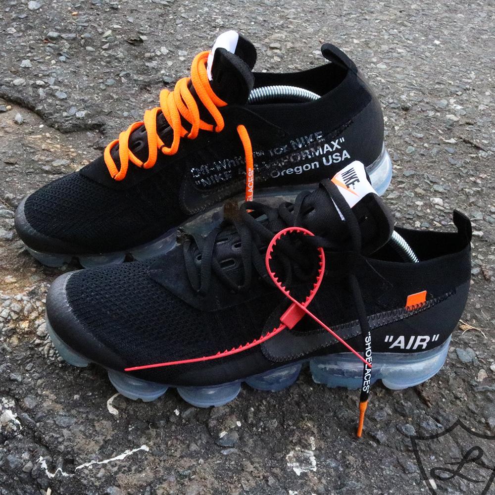 black nike shoes with orange laces