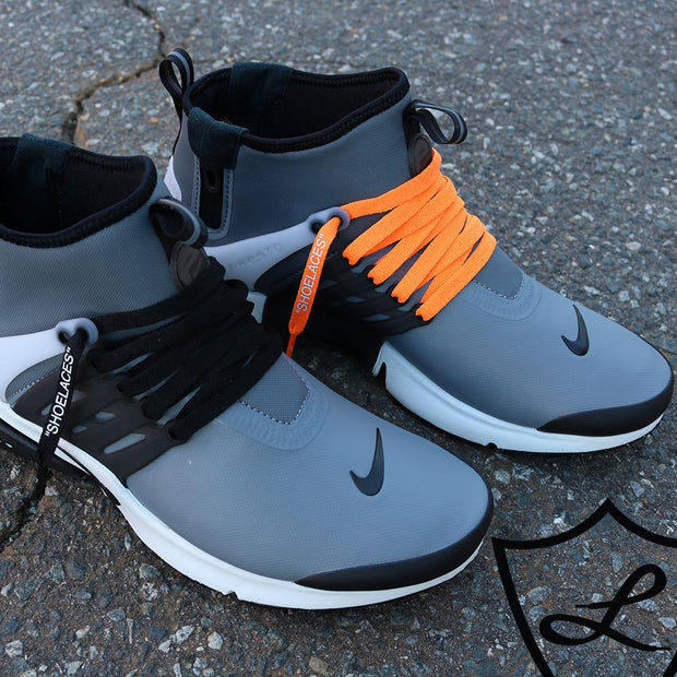 black nike shoes with orange laces