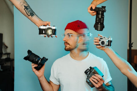 man with multiple cameras