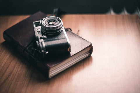 A book with a camera on top of it