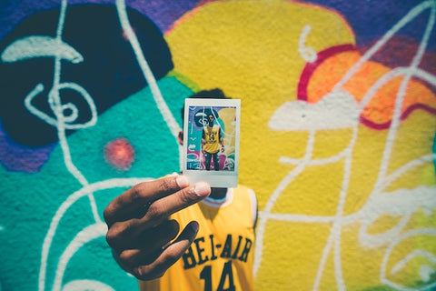 man in front of a graffiti wall