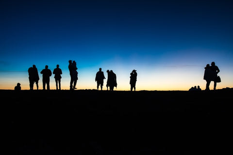 a group of people standing on top of a hill