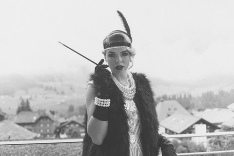 woman in vintage clothes holding a cigarrette