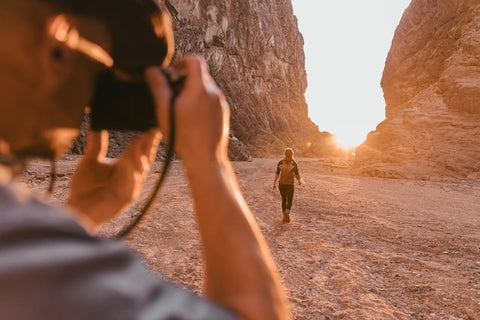 woman taking picture in the desert