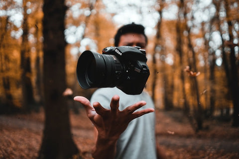 man playing with a camera