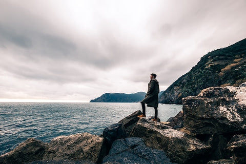 man standing on a boulder