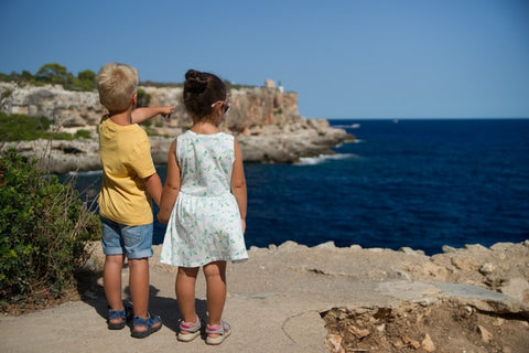 Two kids looking at the sea