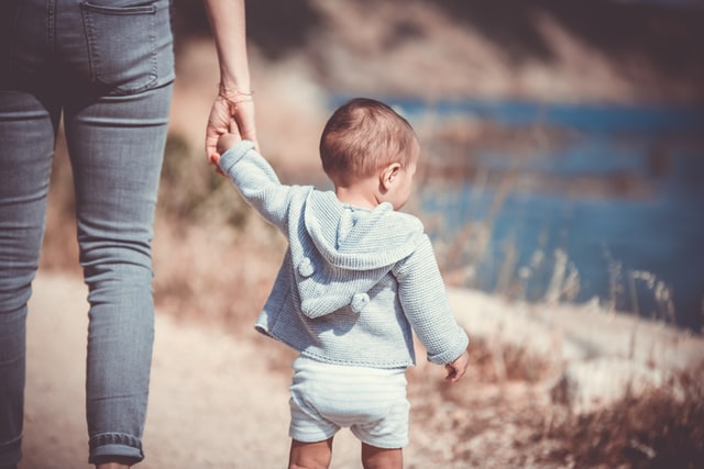 Eco-friendly baby walking with parent