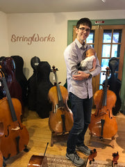 Evan with his child at StringWorks