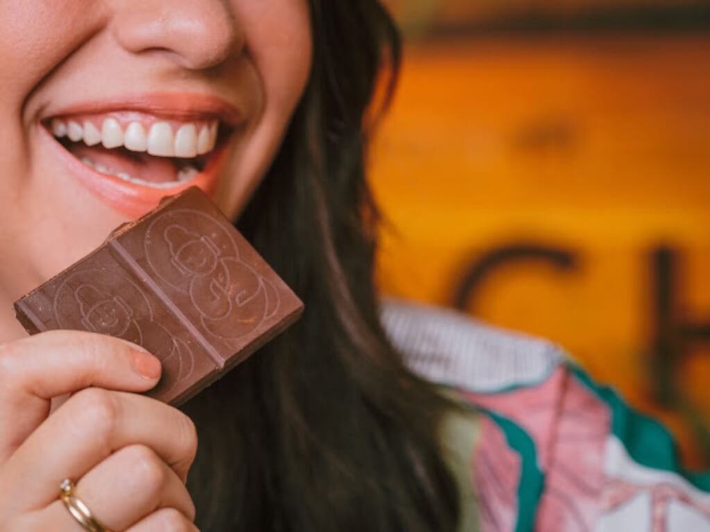 Lady enjoying Cheerful Buddha's CBD chocolate close-up