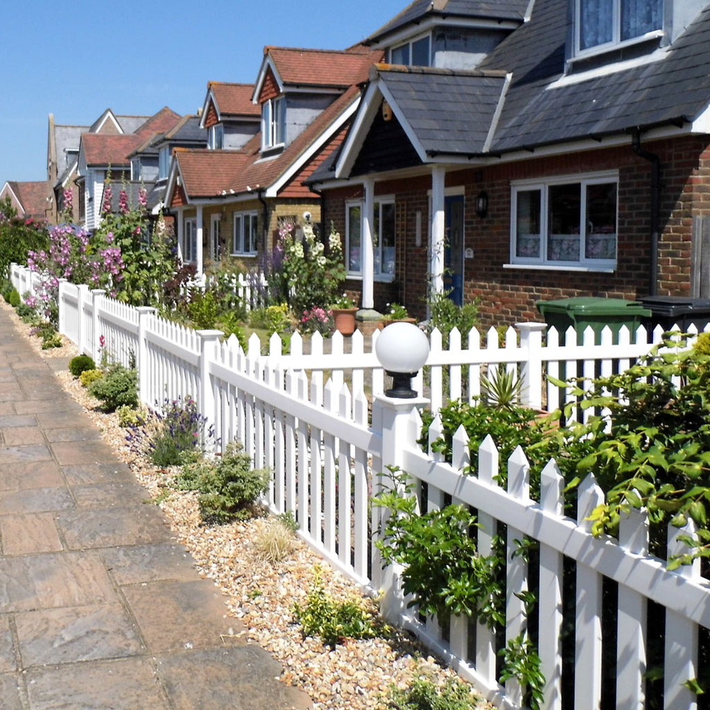 This photo captures the stunning view of a straight picket fence that extends across an entire neighbourhood with over 10 terraced houses. The fence creates a visually appealing and cohesive look, enhancing the beauty of the front gardens. The fence panels are brilliantly white, providing a striking contrast against the vibrant greenery that adorns the gardens. The combination of the immaculate white fence and lush vegetation creates a picturesque scene that adds charm and elegance to the neighbourhood.