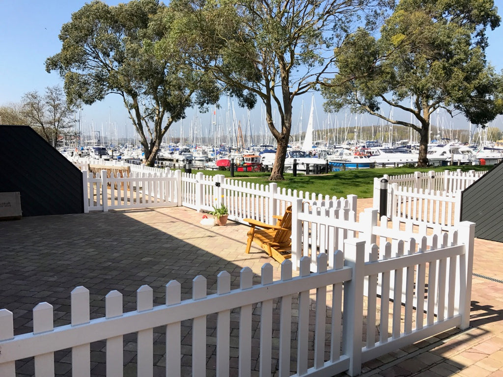 This photo showcases a stunning picket fence situated at one of the marina bays in South England, complementing the picturesque waterfront scenery. The fence's classic design adds a touch of charm and defines the boundary with style.
