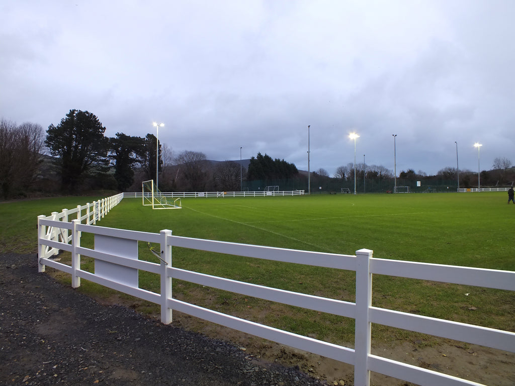 This captivating photo captures an 3-rail equine fence installed at a cricket club stadium during a winter evening. The fence serves as a reliable boundary, defining the field and adding a touch of elegance to the stadium's ambiance.