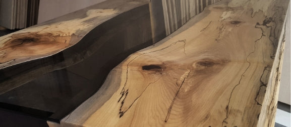 A live edge river table with clear epoxy