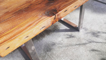A walnut wood slab coffee table with metal legs