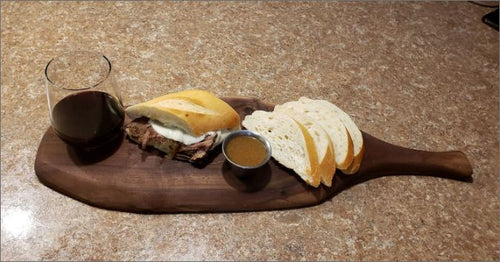 Charcuterie serving board with wine and sandwich