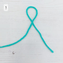 First, we need to make a slip knot. To do this make a loop with your yarn as shown on photo 1.