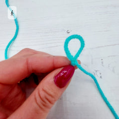 Slowly pull the yarn that leads to the ball of yarn and you will see the loop shrink.
