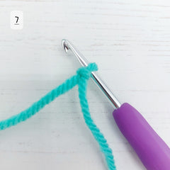 Place the loop over your crochet hook. It should be a touch larger than the hook, so that you can work with it, without it slipping off easily.