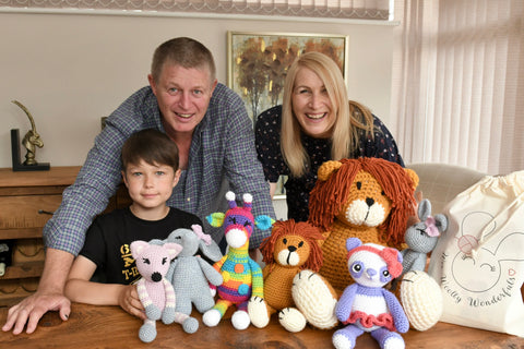 Family sitting with a selection of Amigurumi Animals