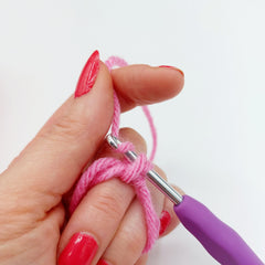 Step 5.  This time putting your hook aver the top of the 2 loops, hook the strand that leads to your ball of yarn