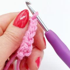 You have now completed your first Double Crochet (DC) stitch!  It looks like a small V shape, as you can see below.