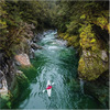 Man kayaking in the lake surrounded by forest