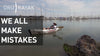 A man who rests on the kayak near the boats