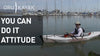 A man in a kayak close to the boats