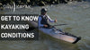 A man kayaked near a cluster of rocks