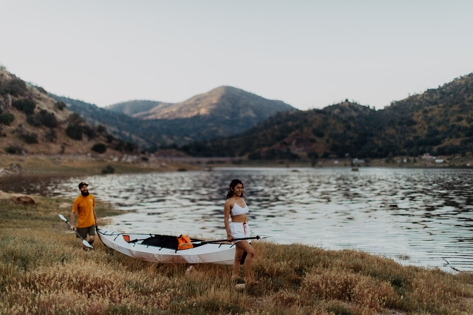 people by the river with their haven tt kayak