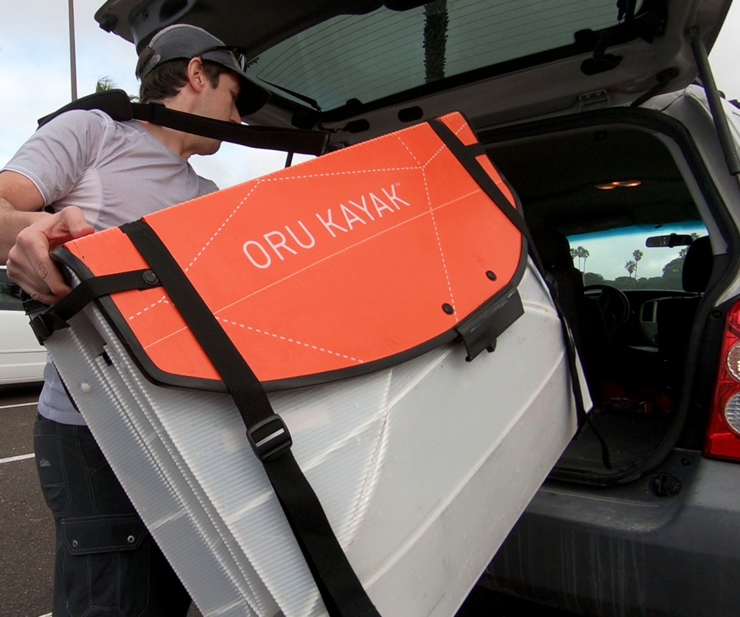 Man loading his Coast XT Kayak (folded) in the truck