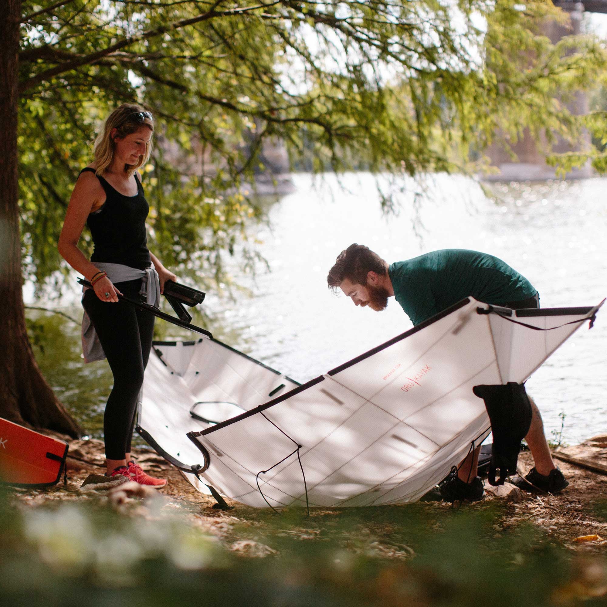 Two people unfolding their bay st kayak 